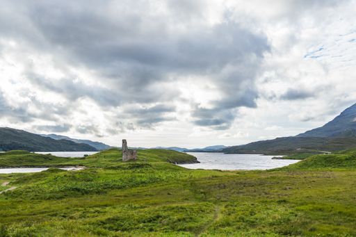 A panoramic shot of Loch Assynt with the ruins of Ardvreck Castle in north west Scotland