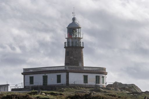 The famous Corrubedo lighthouse under a cloudy sky in Galicia, Spain