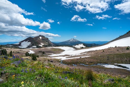 A beautiful scenery of high rocky mountains covered with snow under the breathtaking sky
