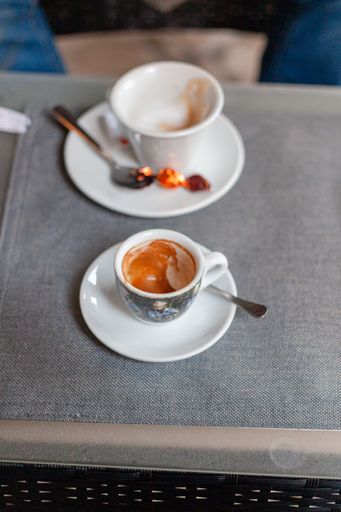 Two empty cups of cappuccino on a table