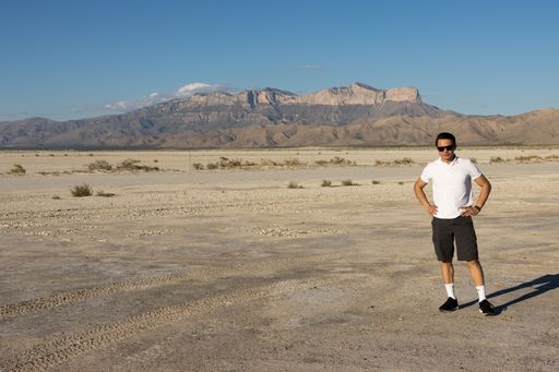 A Young man standing in front of Guadalupe Peak