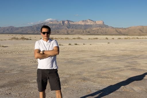 A Young man standing in front of Guadalupe Peak