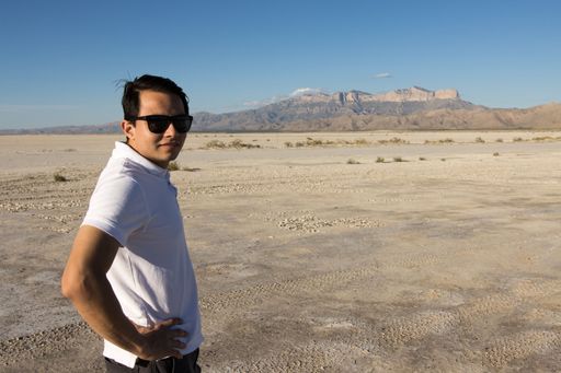 A Young man standing in front of Guadalupe Peak