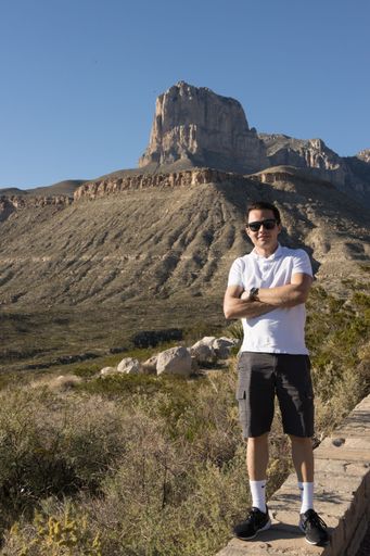 A Young man standing in front of Guadalupe Peak