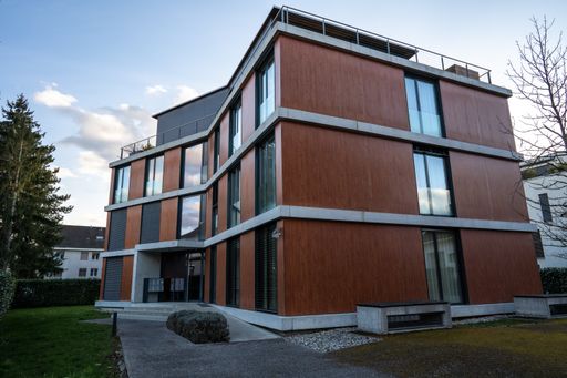 An exterior view of a modern house building on a clear sky background