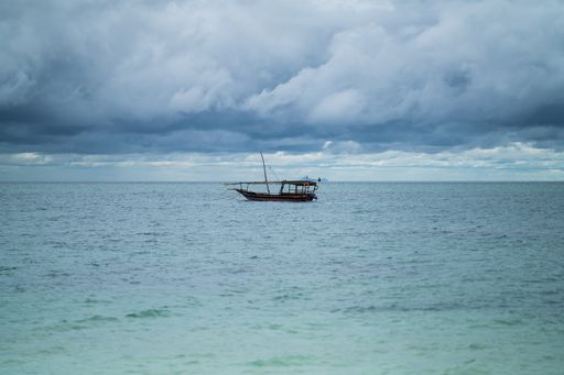 A closeup shot of a fishing boat against a cloudy sky background on Zanzibar island