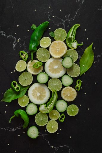 A close-up image of a trio of fresh produce on a black table surface