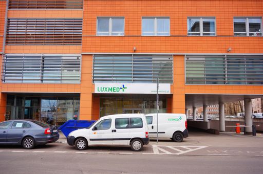 Parked cars in front of a Luxmed medical office in the Globis building on the Slowackiego street in the city center.