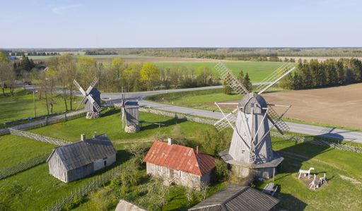 An aerial shot of a farm with old windmills, h and cultivated lands