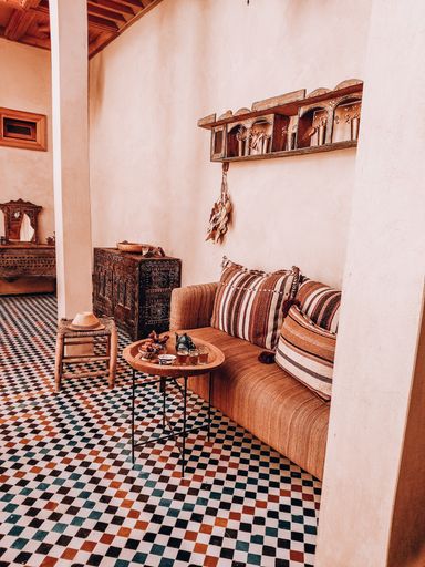 A traditional Moroccan room with a couch and tea set for enjoying Ramadan tea time