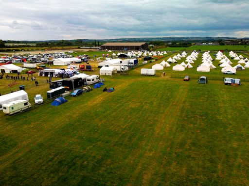 A stunning outdoor shot of a campsite set up in a lush meadow in Slapton, United Kingdom.