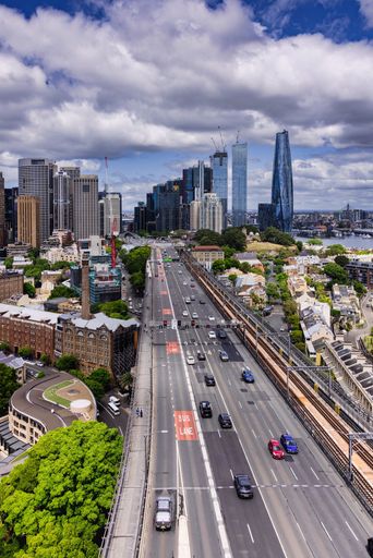 Aerial view of a busy city freeway on a sunny day in Sydney, Australia