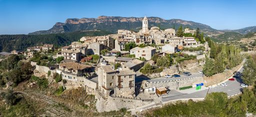 An aerial view of a medieval village on top of a hill