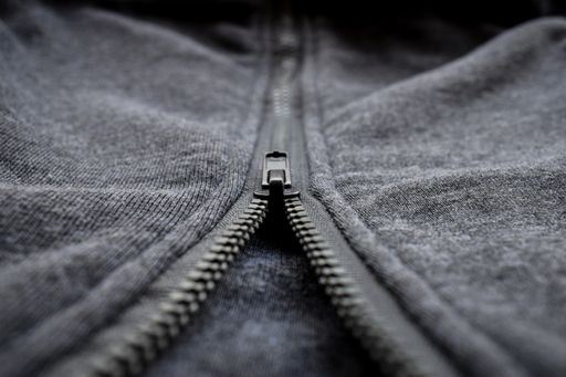 A macro shot of the zipper of a wool texture sweater