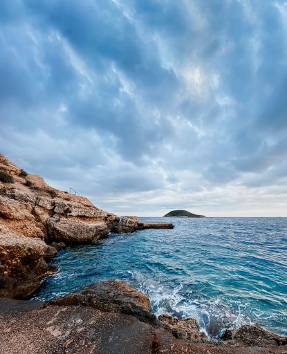 The beautiful view of cliffs and blue waters on a cloudy day. Mallorca, Spain