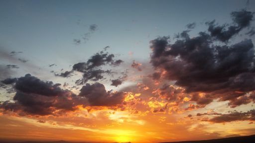 A scenic view of the beautiful sunset sky with dark clouds - great for wallpaper of desktop