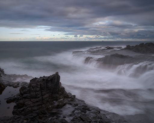 A mesmerizing view of waterfalls with long exposure in Gran Canaria, Canary Islands during sunset