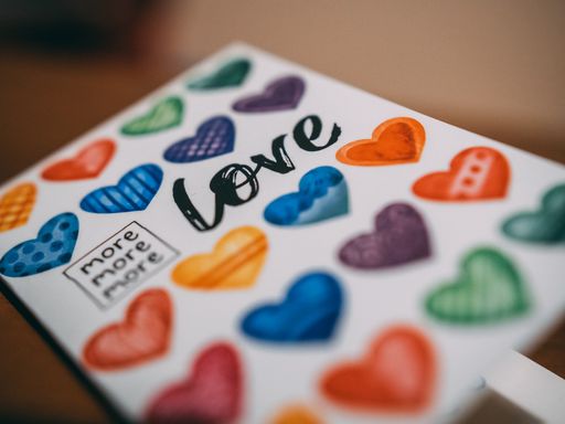 A colorful copybook with hearts and love written on it