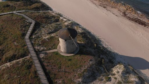 The ancient windmill and storerooms near the road in schist of Apulia, Esposende, Portugal