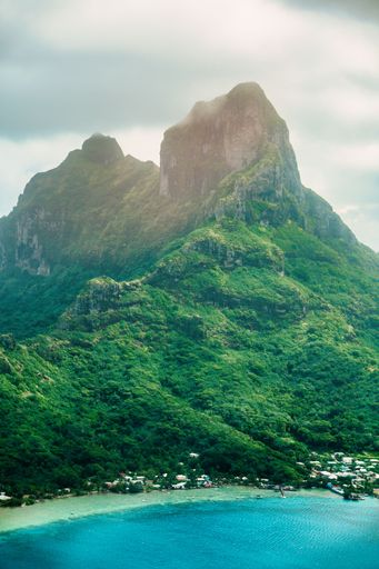 A picturesque landscape with majestic peaks covered with lush greenery. Bora Bora, French Polynesia