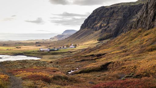 A picturesque landscape featuring a river winding through a vast field.