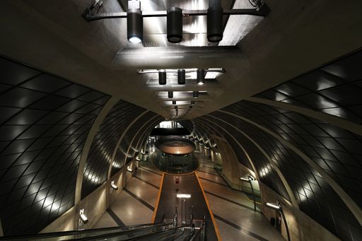 A bustling train station with an active escalator in motion, providing an efficient way for passengers to get to their destination