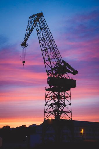 Silhouette of Carola crane in Bilbao Spain with a scenery of sunset in the background