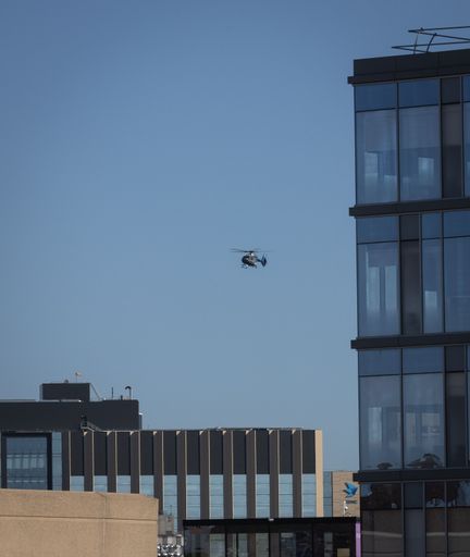 An aerial view of A medical helicopter prior to landing on a hospital in Boston