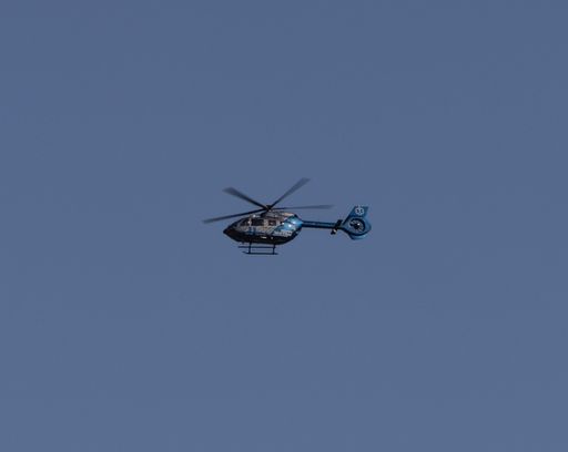 An aerial view of A medical helicopter prior to landing on a hospital in Boston