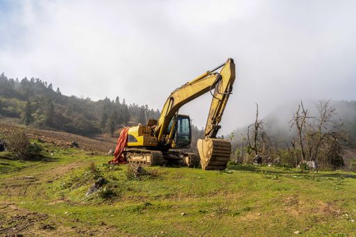 An excavator working in the field and digging the earth