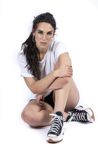 A pretty woman in sportswear posing in a photo studio