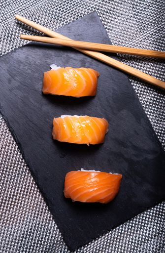A tray with delicious nigiri sushi with chopsticks