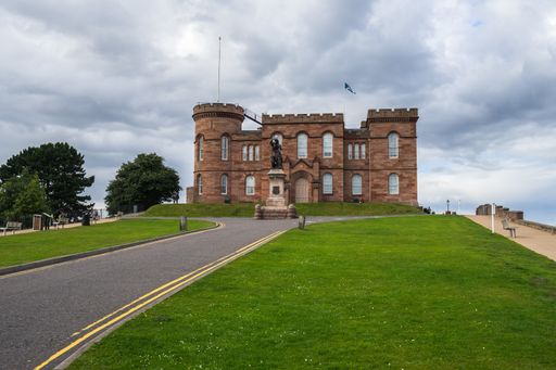 A long shot of the famous Inverness Castle in Scotland under a cloudy sky