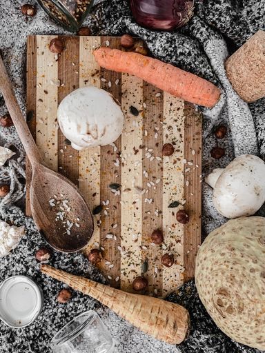 A vertical top view of various spices, seasonings and ingredients on a cutting board