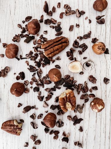 A vertical top view of nuts and chocolate chips on a kitchen table