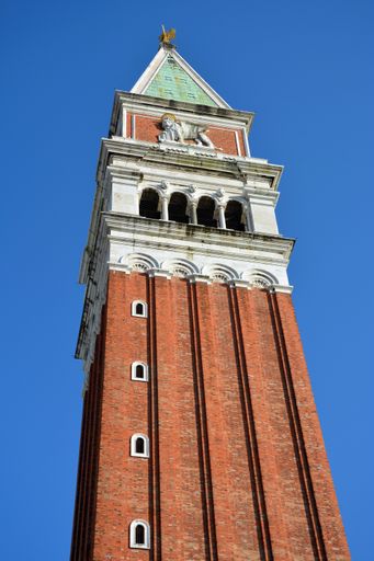 A vertical shot of St. Marks Campanile in Venice isolated on a blue background