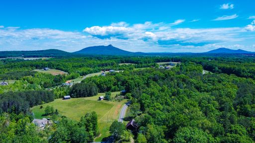 A pilot mountain and Sauratown Mountains on the horizon above the NC countryside