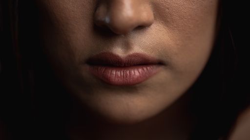A closeup shot of the lower part of an African American female's face