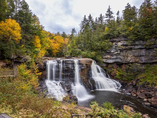 A tranquil scene of Upper Lake State Park in New Hampshire, Massachusetts, with a majestic waterfall cascading into the lake below