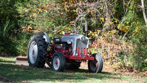 A tractor parked in a grassy field