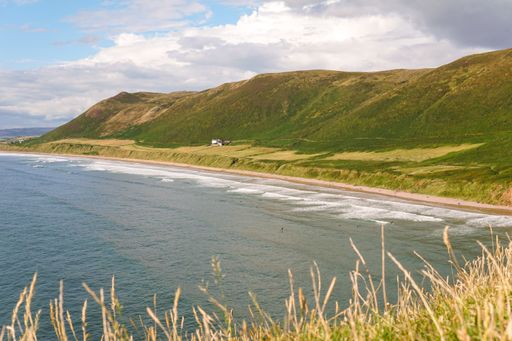 The hills on the coast of a lake in Rhossili, Wales