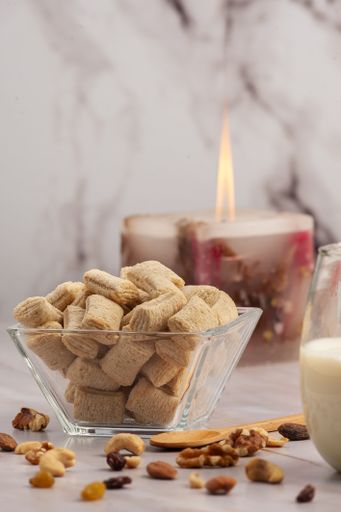 A vertical closeup shot of a gourmet bowl of cereal on a kitchen table