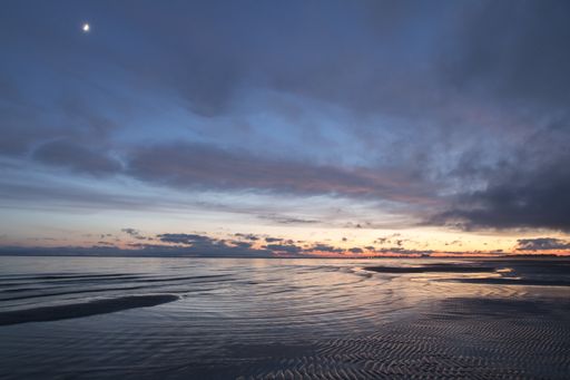A beautiful sunset on the lake with a cloudy, pink sky, Estonia