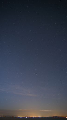 A vertical low angle shot of the night sky