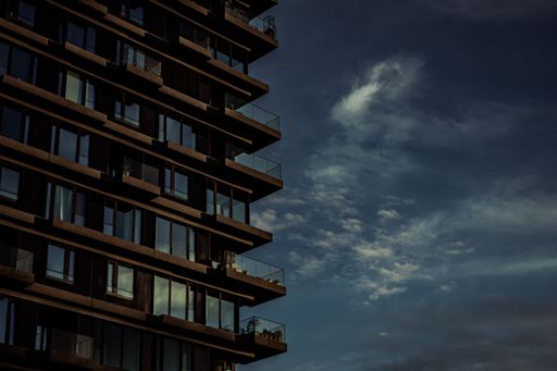 A modern building in Berlin, Germany with a cloudy blue sky in the backdrop