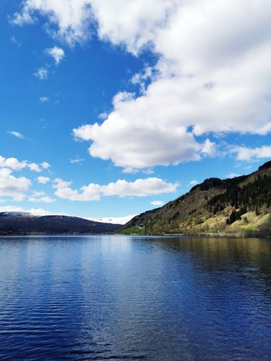 A scenic shot of the Oppheimsvatnet lake in Norway surrounded by mountains on a cloudy weather