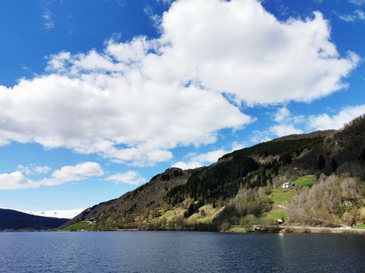 A scenic shot of the Oppheimsvatnet lake in Norway surrounded by mountains on a cloudy weather
