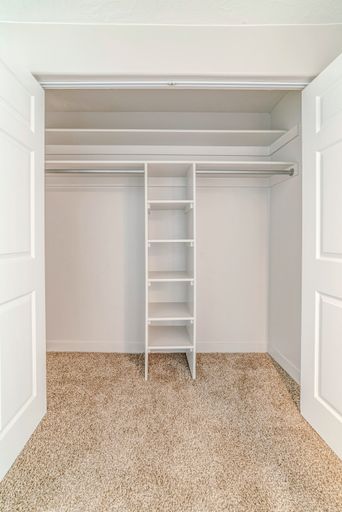 A minimalistic closet interior design in white color with empty racks