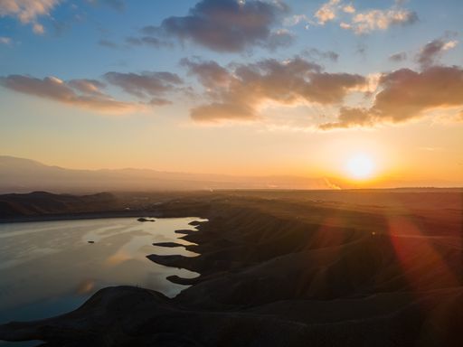 Aerial view during the sunset. Landscape view of hills and a lake during the sunset.