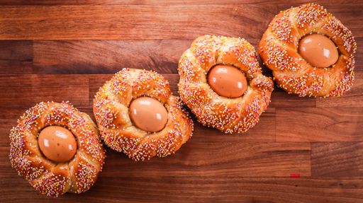 An overhead shot of freshly baked Italian Easter bread topped with egg an colorful sprinkles